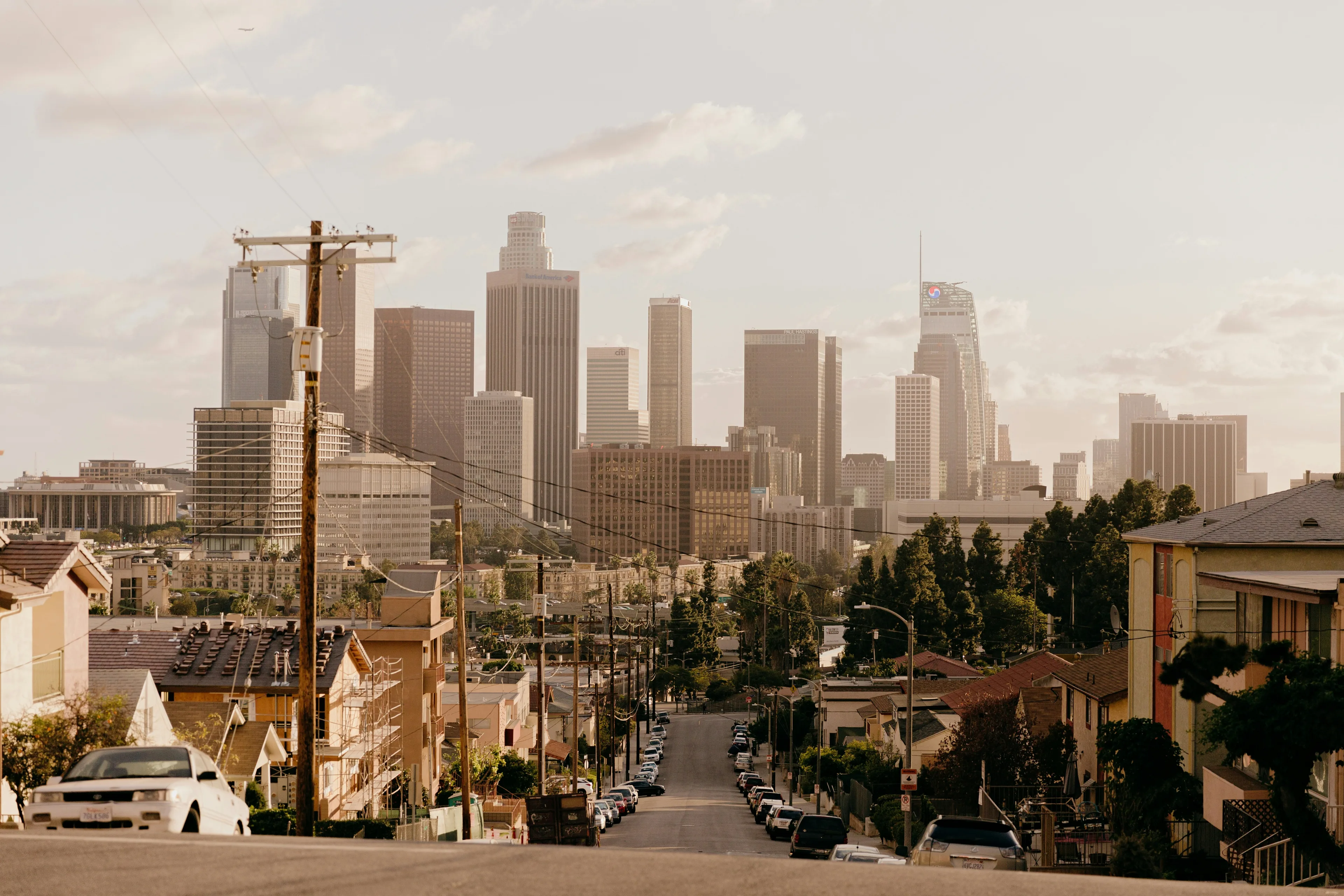 An image of the Los Angeles skyline with power lines in the foreground.